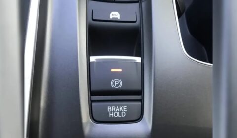 Electronic parking brake switch above a button labeled BRAKE HOLD