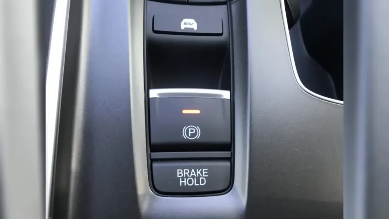Electronic parking brake switch above a button labeled BRAKE HOLD