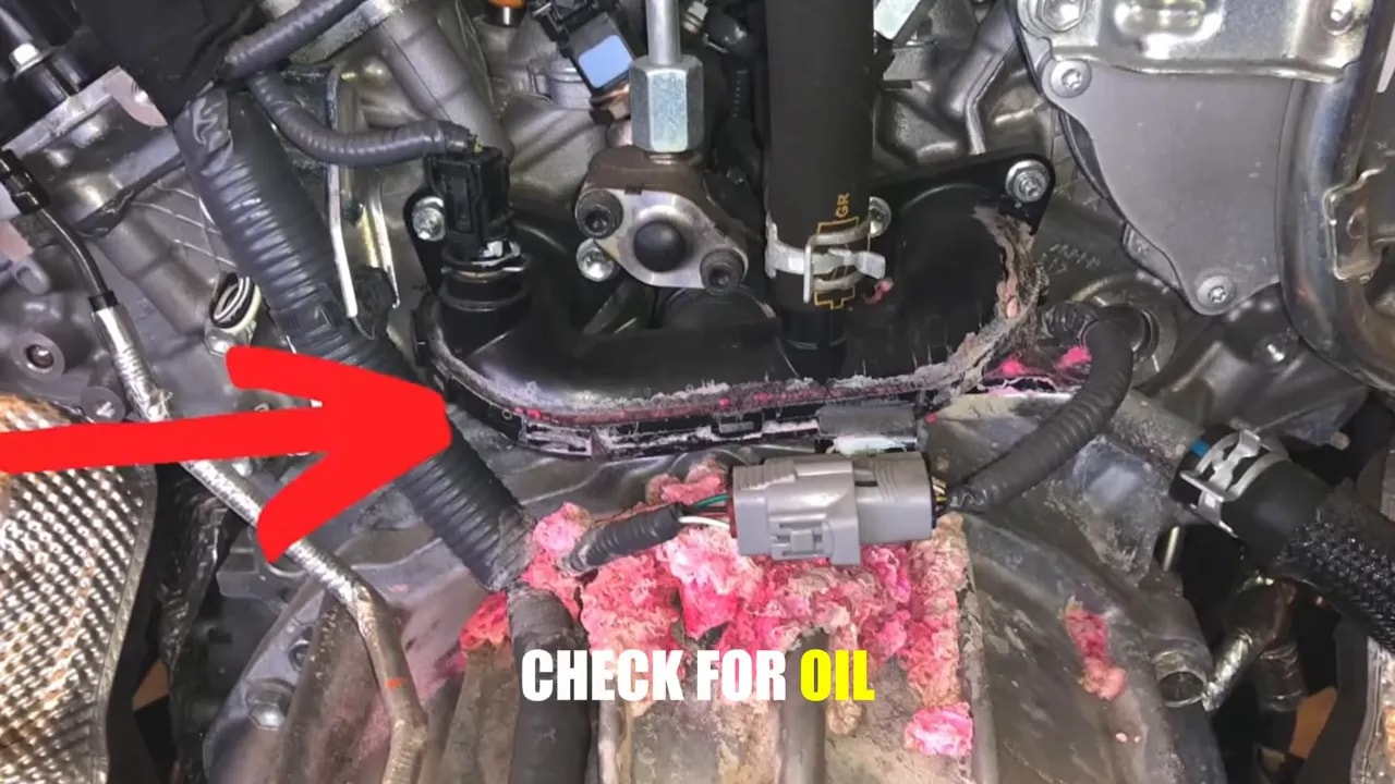 Close-up of engine components with a red arrow pointing toward a seam