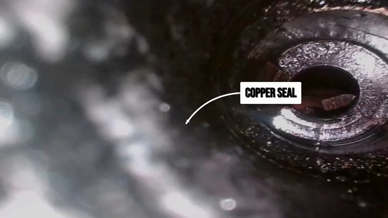 Close-up of an injector seat with a copper seal label