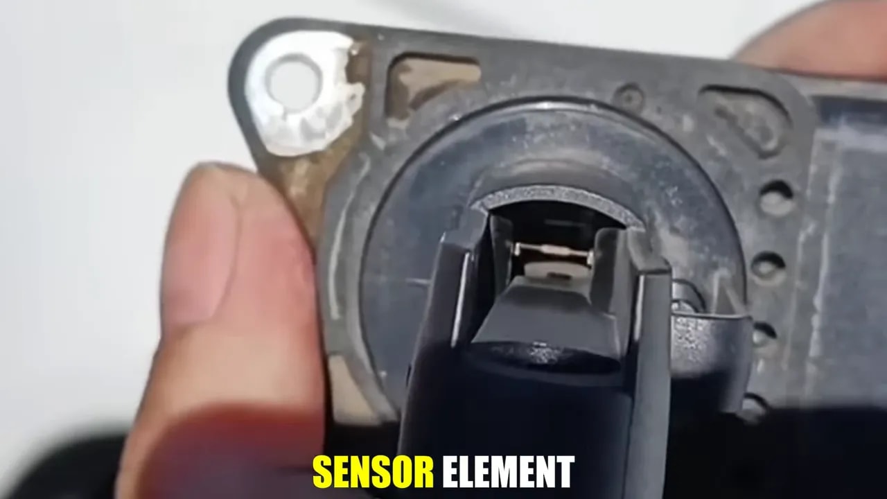 Close-up of a removed sensor showing the small sensing structure inside its opening
