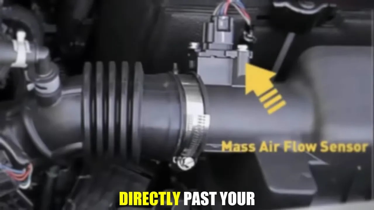 Yellow arrow and Mass Air Flow Sensor label pointing to a sensor on an intake duct