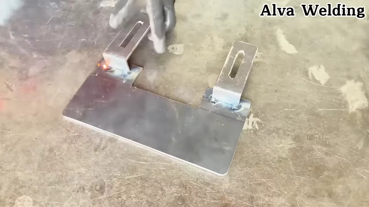 Welding adapter mounting tabs onto a metal plate for an angle grinder DIY adapter